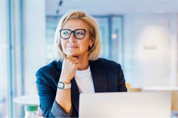 A professional person sits at a laptop