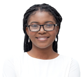 A young professional smiles in a portrait in front of a simple gray background