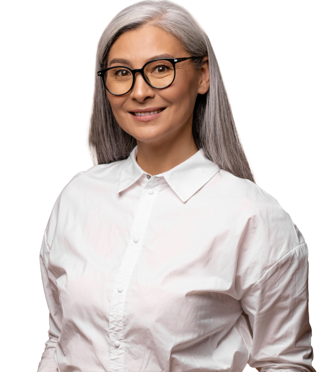 A professional businessperson in a white button up shirt smiles at the camera in a portrait