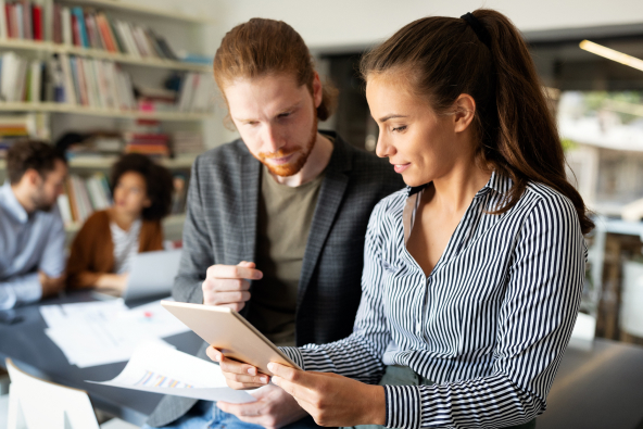 Two colleagues discuss a document