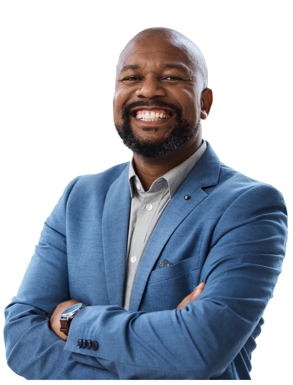 A businessman in a blue blazer smiles and poses with arms crossed across his chest