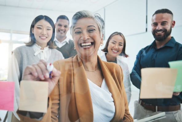 A group of colleagues around a work board